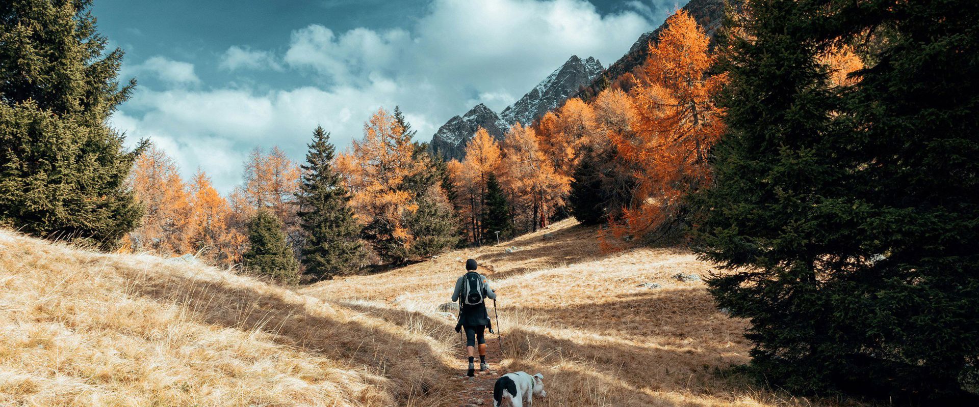 Wanderer mit Hund im Meraner Land im Herbst